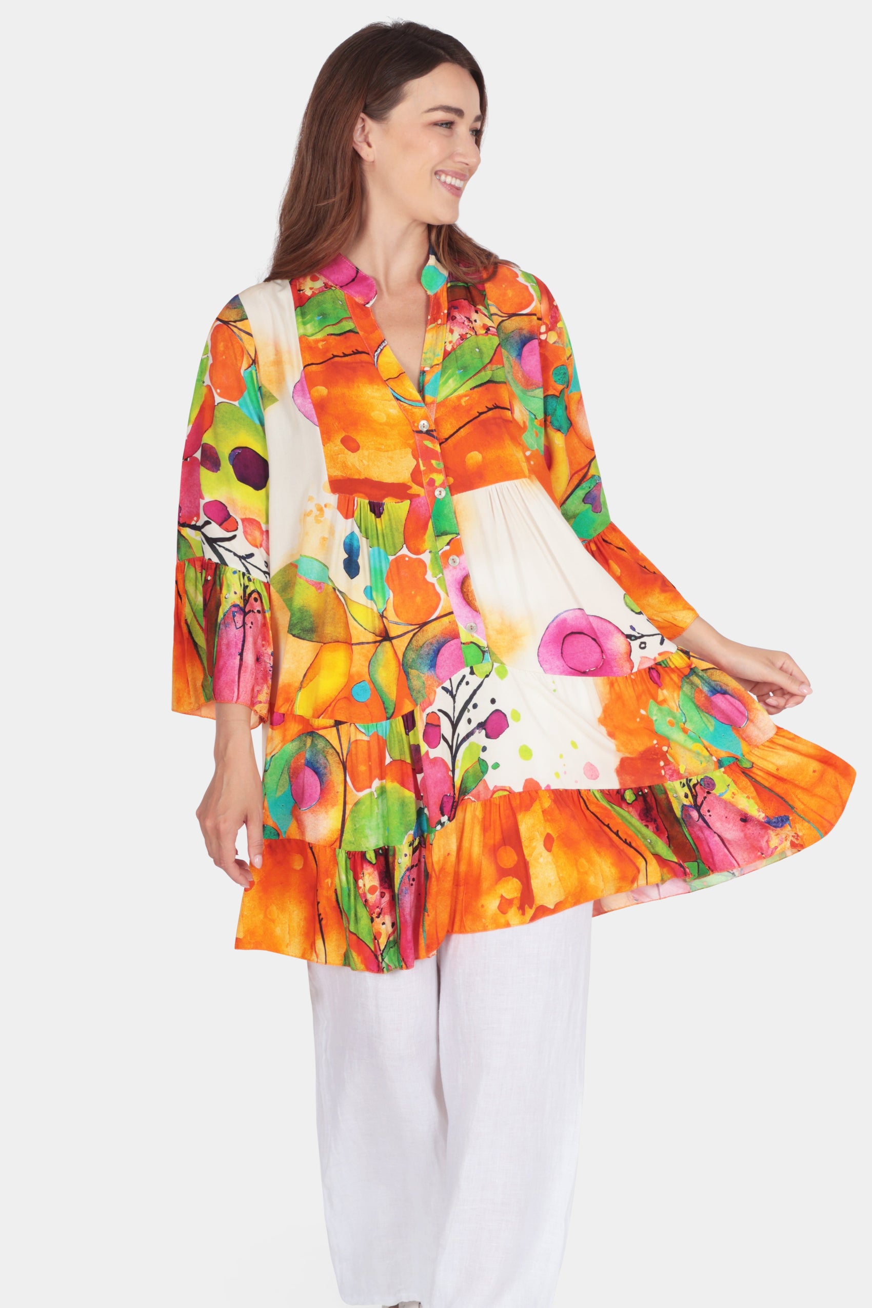 Artistic Flutter Tunic Dress with vibrant abstract print, split V-neck, bell sleeves, and playful flutter tiers.