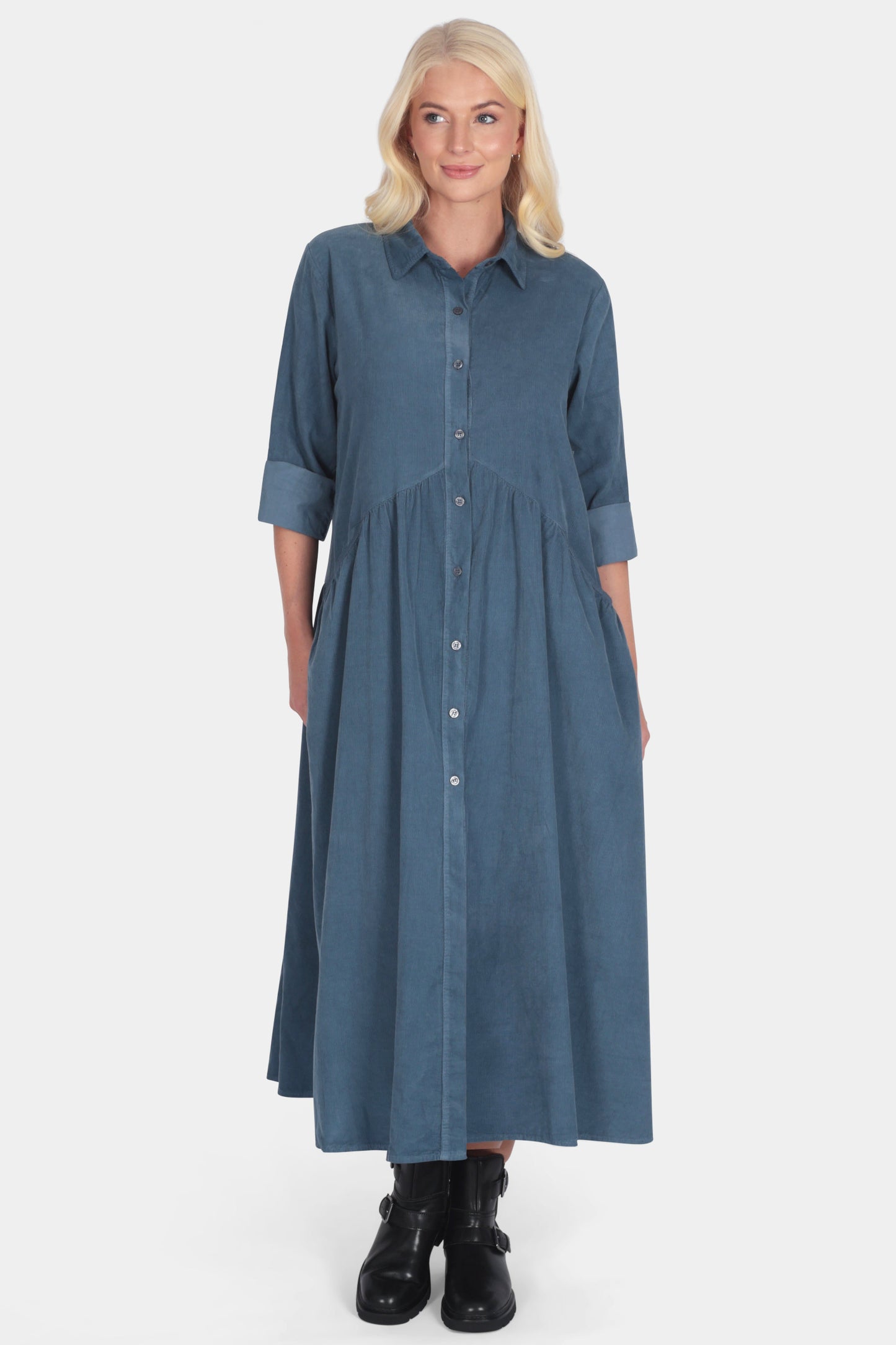 Woman wearing a blue cotton corduroy shirt smock dress 