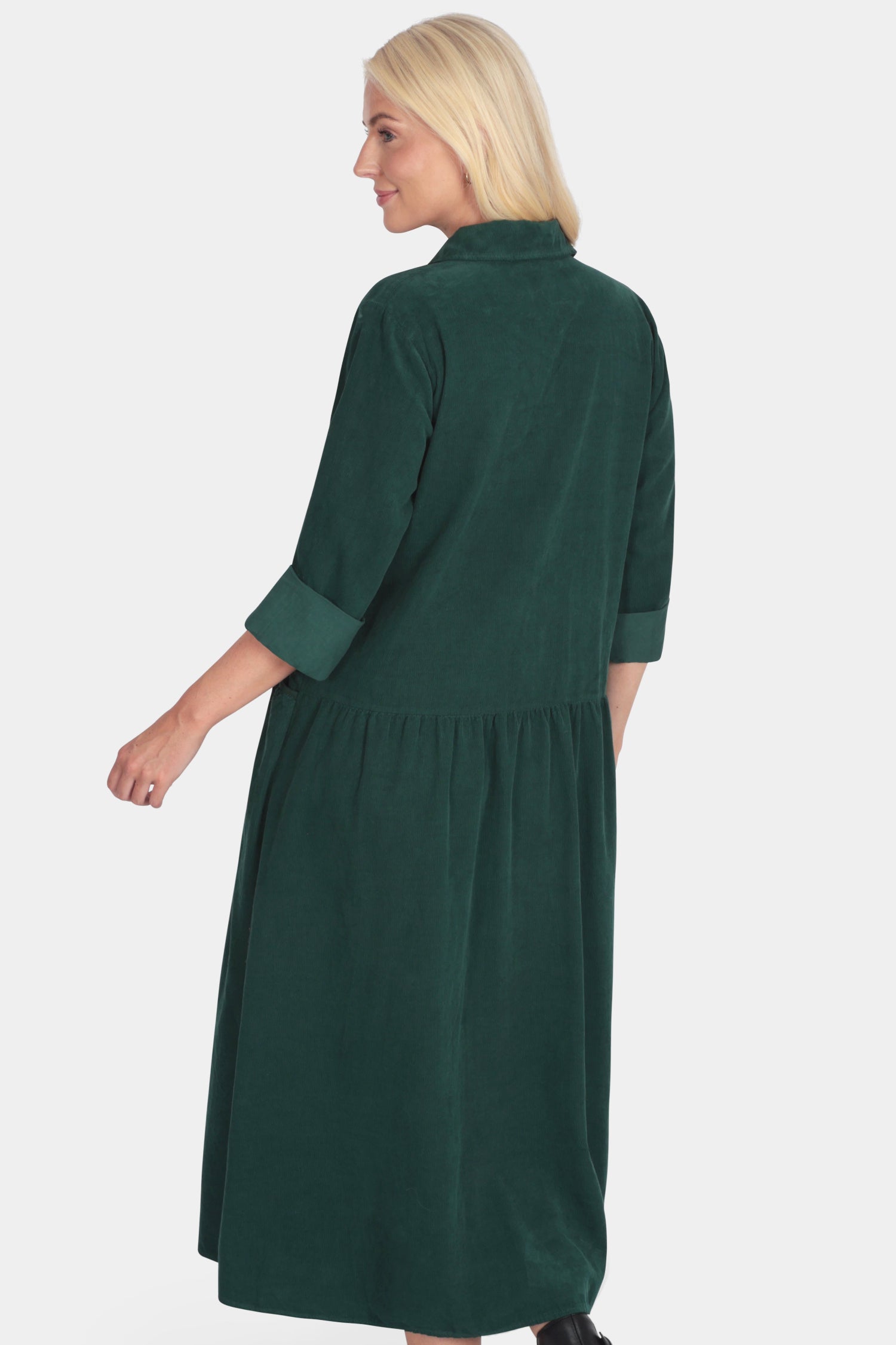 Woman wearing a green dress on a white background