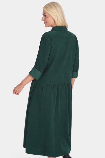 Woman wearing a green dress on a white background