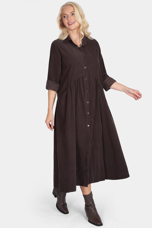 Woman wearing a brown dress on a white background