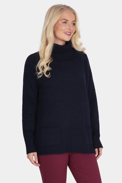 Woman wearing a black turtleneck sweater and burgundy pants on a white background