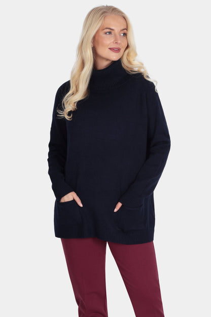 Woman wearing a black turtleneck sweater and burgundy pants on a white background