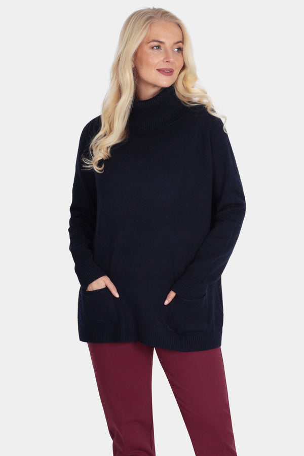 Woman wearing a black turtleneck sweater and burgundy pants on a white background