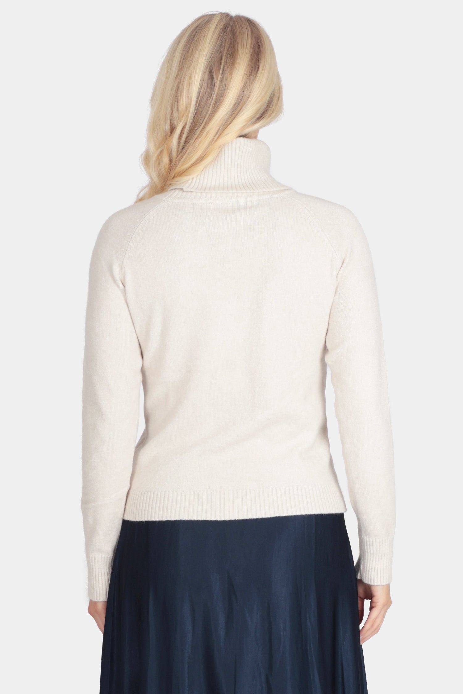 Person wearing a white shirt and navy skirt on a white background