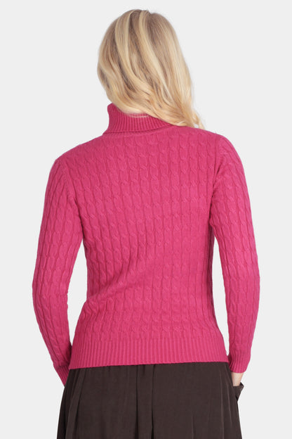 Person wearing a pink sweater and brown skirt on a white background