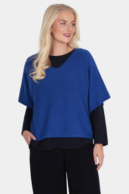 Woman wearing a blue and black outfit on a white background