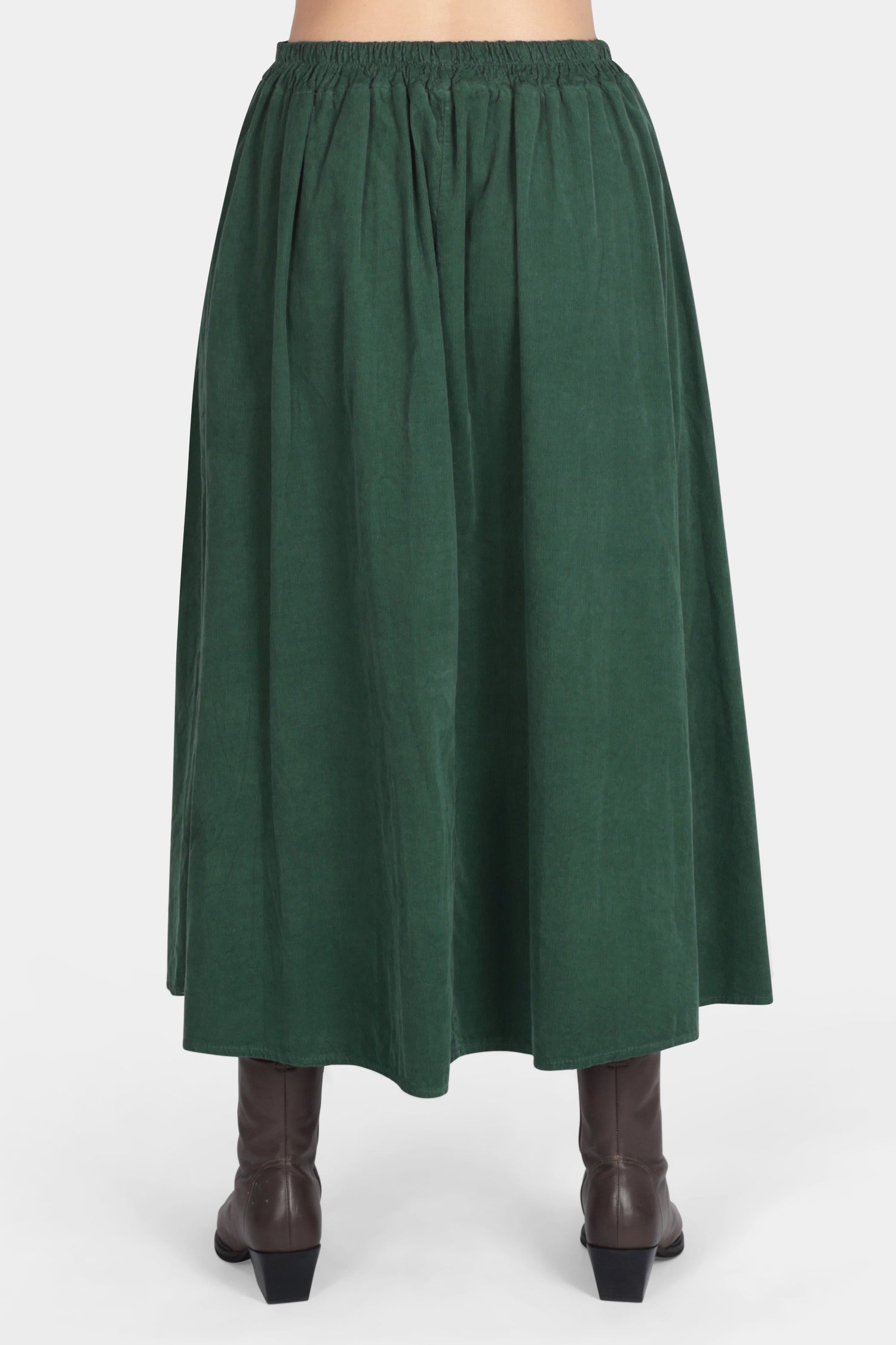 Green skirt worn by a person on a white background