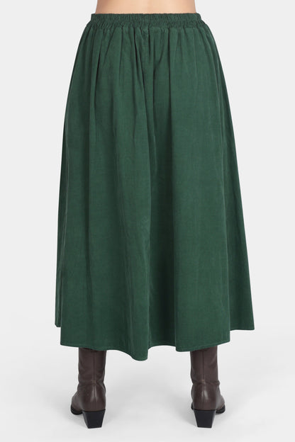 Green skirt worn by a person on a white background