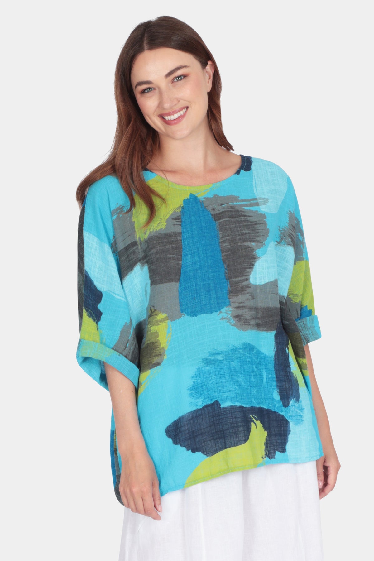 Woman wearing Lina Canvas Cotton Top with abstract brushstroke print and rolled-up 3/4 sleeves on white background