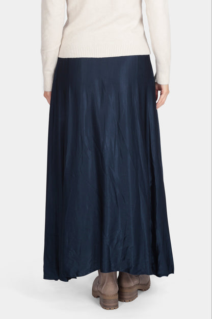 Person wearing a white shirt and navy skirt on a white background