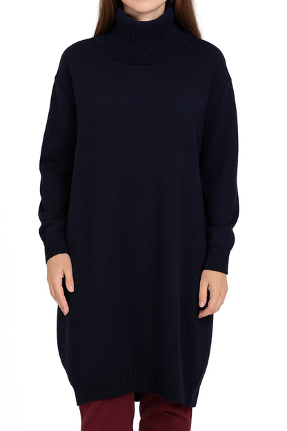 Woman wearing a long black sweater and red pants on a white background