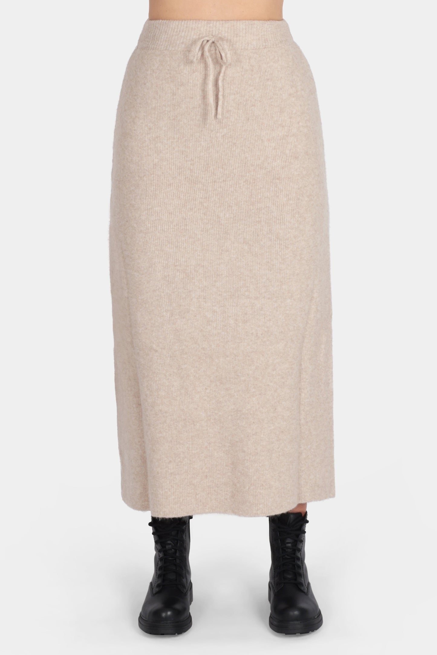 Beige skirt worn by a person on a white background